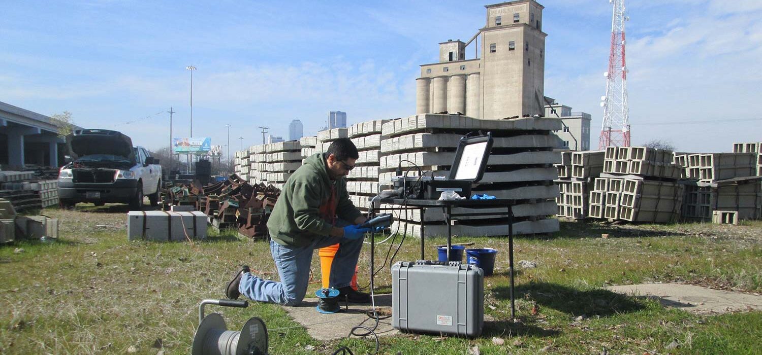 crew member working on equipment near Dallas DART environmental project