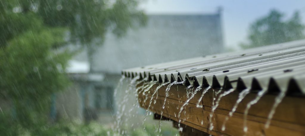 rain flowing down off a metal rural roof